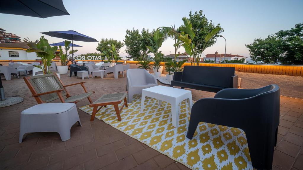 a patio with furniture and tables and chairs at Pato Rojo in Punta Umbría