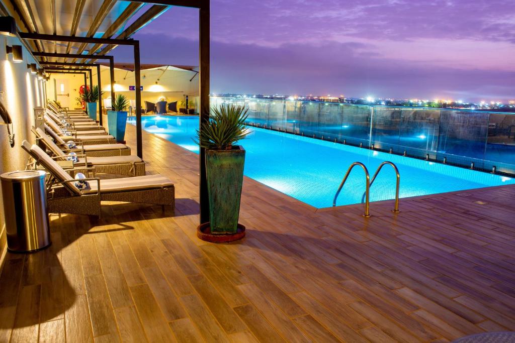 a swimming pool on the roof of a building at Hilton Garden Inn Nairobi Airport in Nairobi