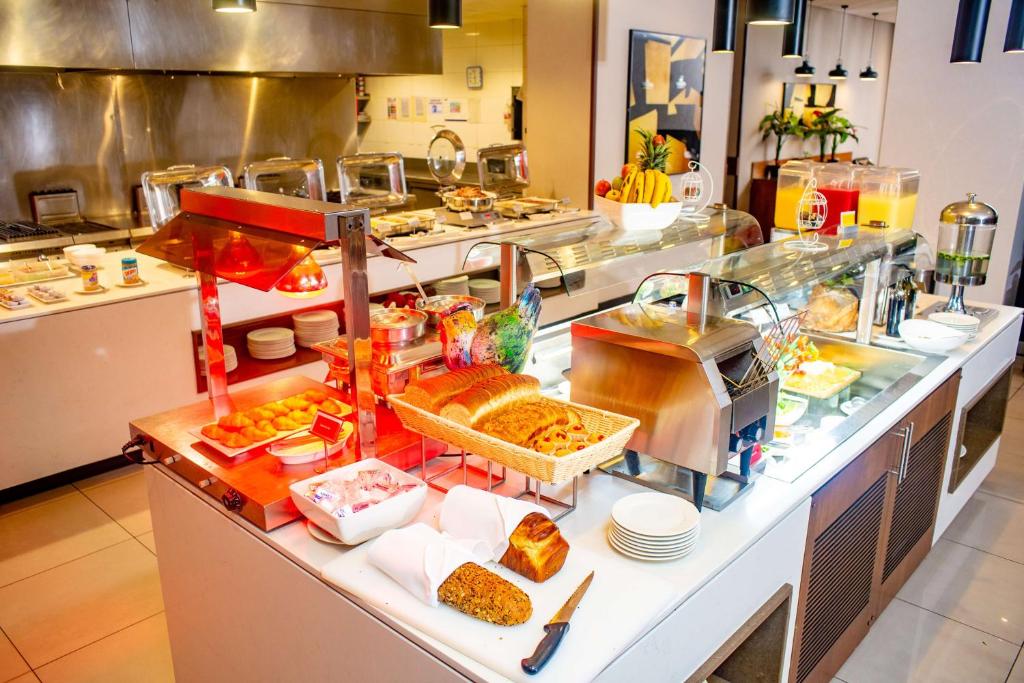 a buffet line in a restaurant with a lot of food at Hilton Garden Inn Nairobi Airport in Nairobi