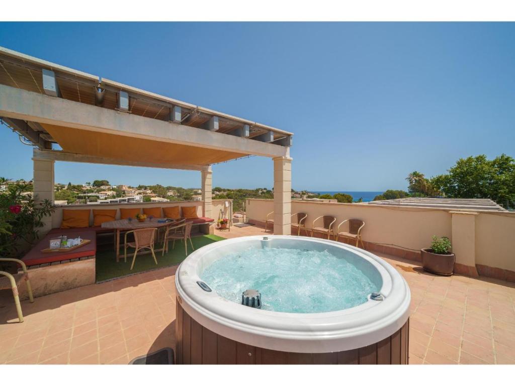 a hot tub on the roof of a house at Apartment Penthouse Las Palmeras by Interhome in Cala Romantica