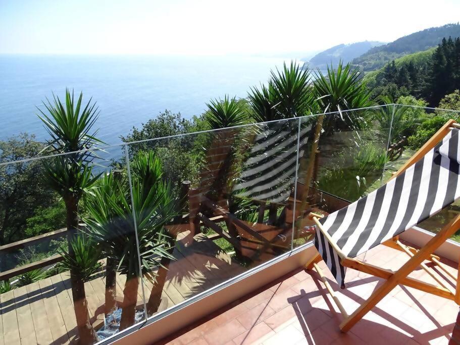 a balcony with a view of the ocean at PIPER ETXEA Relax, mar y monte! in Mutriku