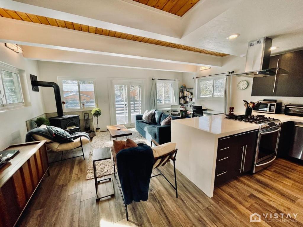 a kitchen and living room with a stove top oven at Aspen Alcove - Amazing Views Private Hot Tub in Park City