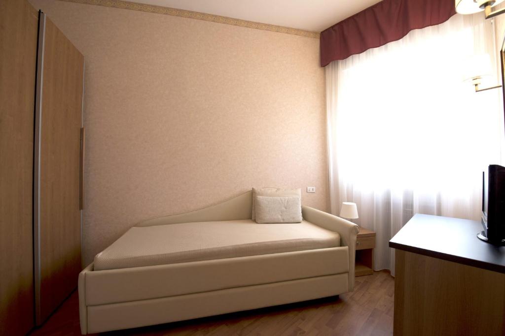 Postel nebo postele na pokoji v ubytování Hotel Benini