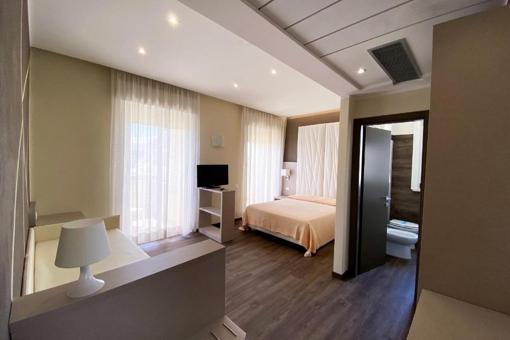 Postel nebo postele na pokoji v ubytování Hotel Benini