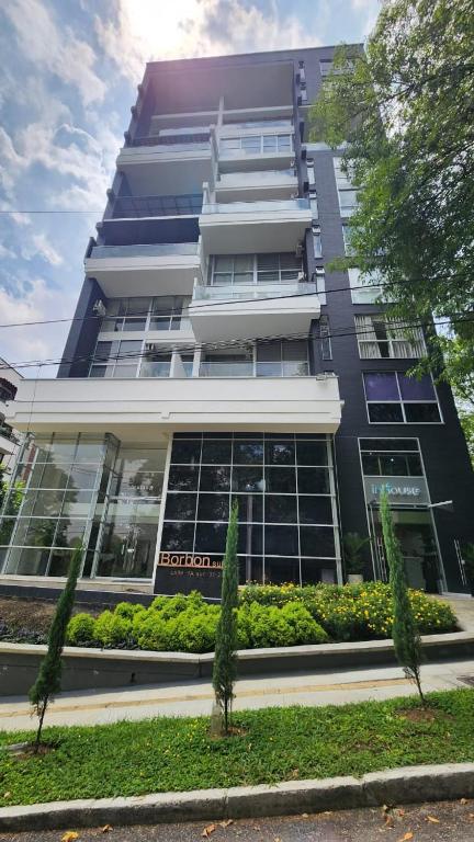 a tall black building with a lot of windows at Apartamentos Borbon Suites in Medellín