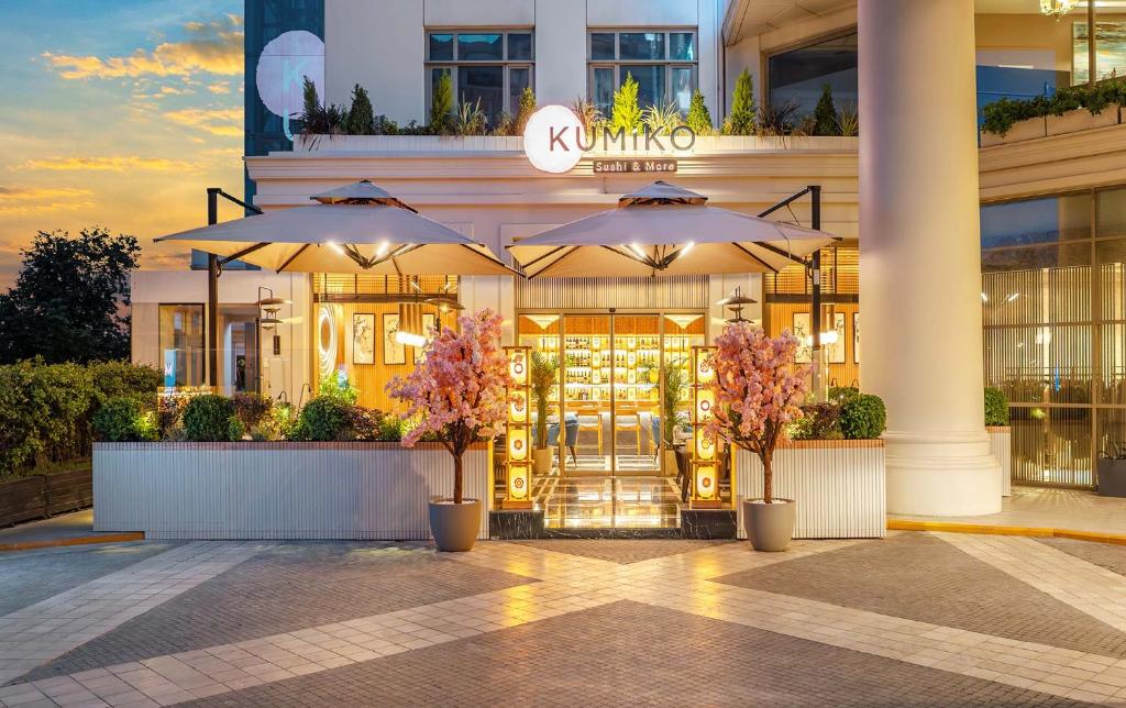 a store with umbrellas in front of a building at CVK Park Bosphorus Hotel Istanbul in Istanbul