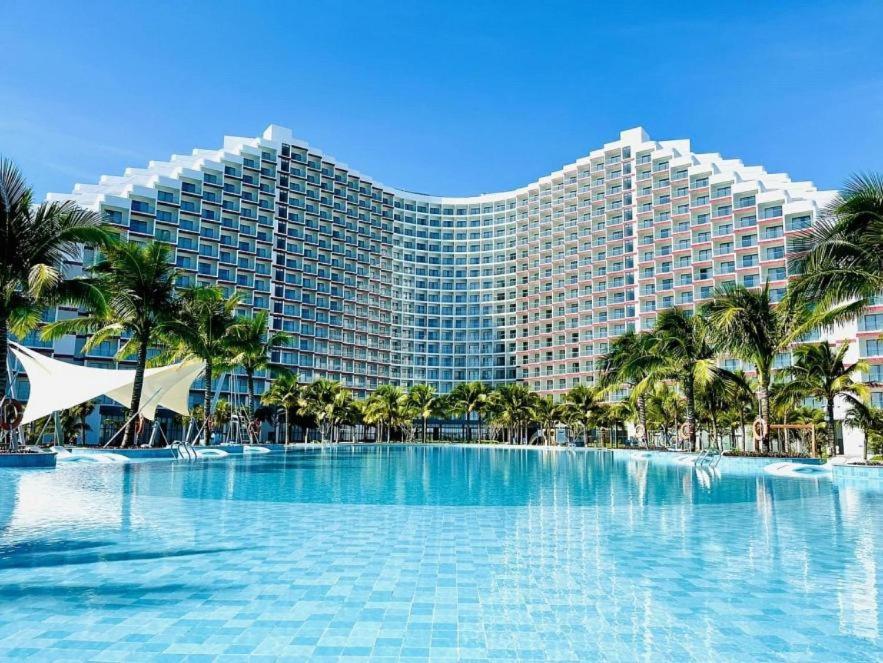 a large resort building with a large swimming pool at Holi Arena Cam Ranh Seaview Premier Apartment in Thôn Hòa Ða