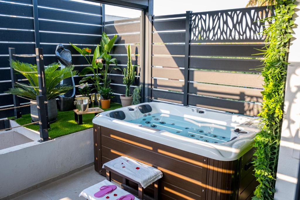a hot tub on a balcony with plants at Dolce Vita, Spa, Cagnes Sur Mer in Cagnes-sur-Mer