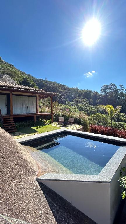 a swimming pool in front of a house at Villa Zarandi - Luxo e conforto que você procura! in Petrópolis