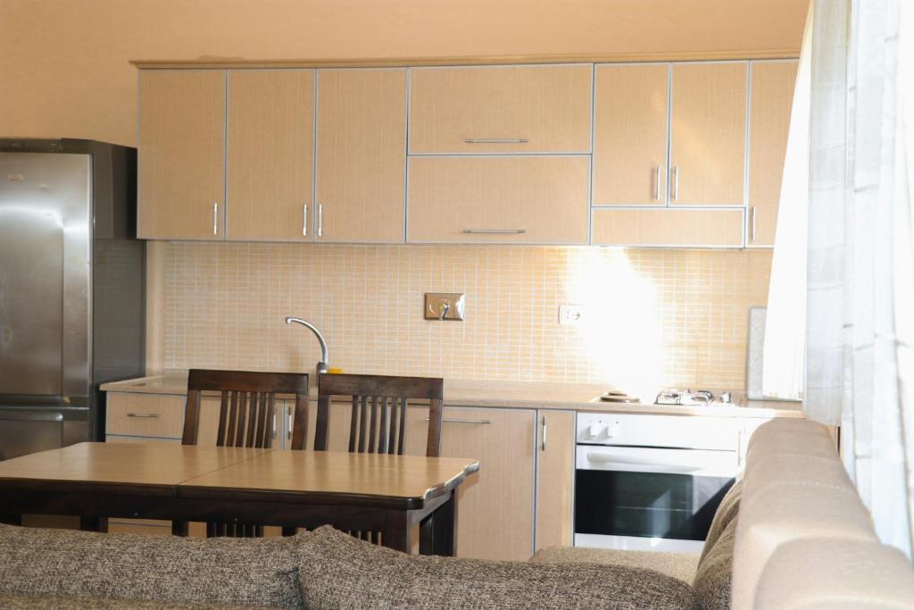 a kitchen with a couch and a table in a kitchen at Villa Apet 23 in Shkodër