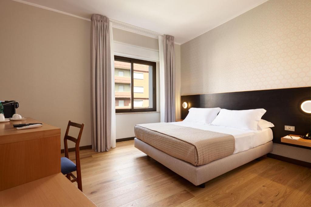 Postel nebo postele na pokoji v ubytování Antum Hotel