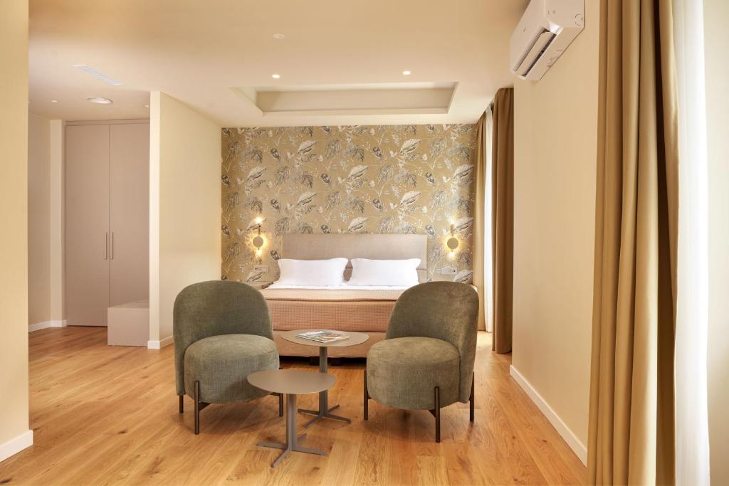 Postel nebo postele na pokoji v ubytování Antum Hotel