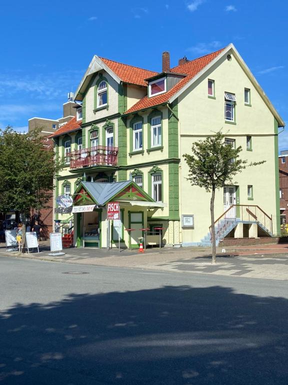a large green building on the side of a street at Stranddüne in Cuxhaven