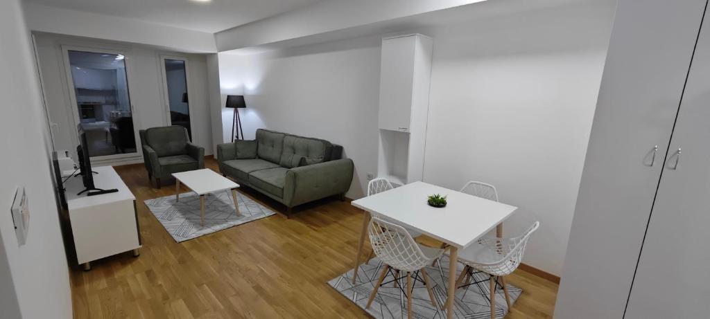 a living room with a couch and a table and chairs at Relaxing property in Skopje