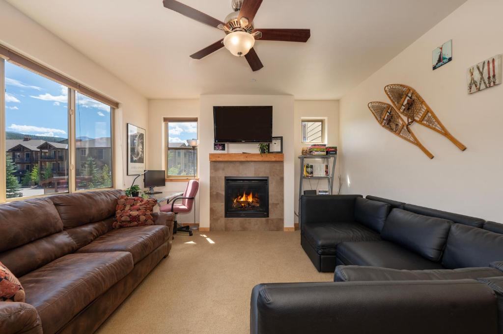 a living room with a couch and a fireplace at Trailhead Lodges 821 in Winter Park