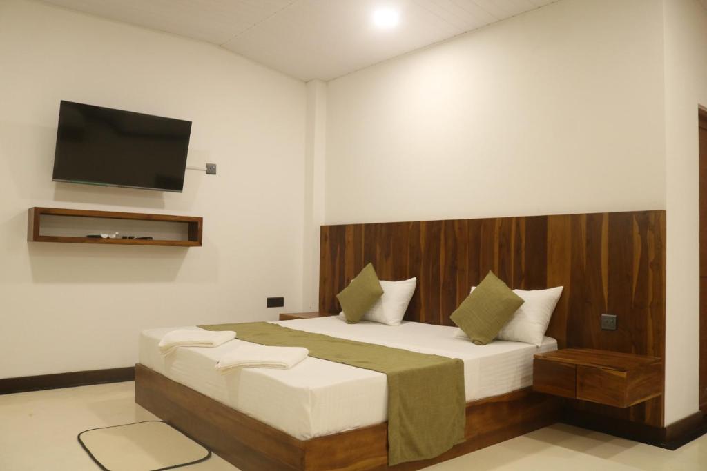 Postel nebo postele na pokoji v ubytování New Sandra Guesthouse
