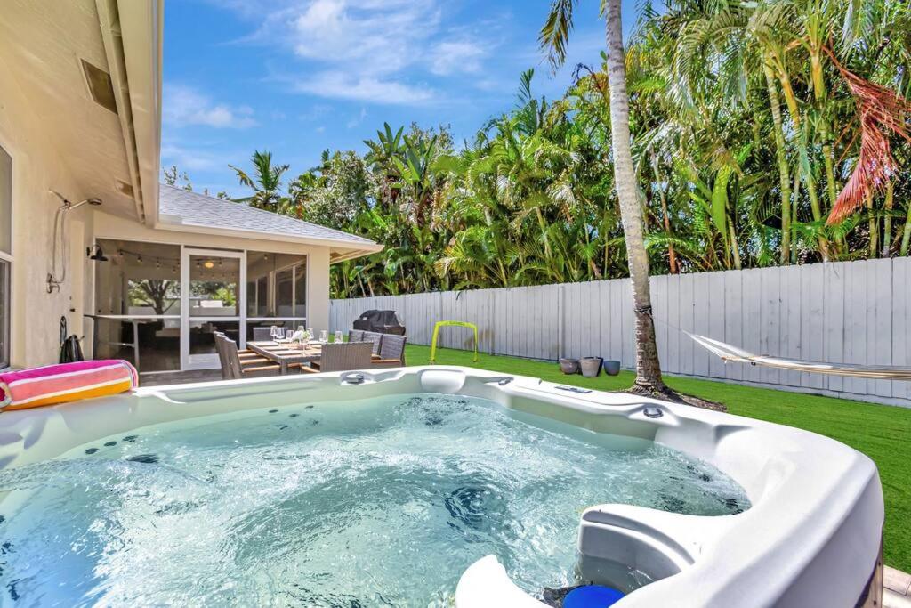 a hot tub in the backyard of a house at Hottub! Mini Golf! Water Access! Pets! 5min beach! in West Palm Beach
