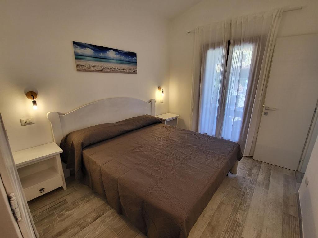 Postel nebo postele na pokoji v ubytování Residence Lu Lamoni Costa Nord