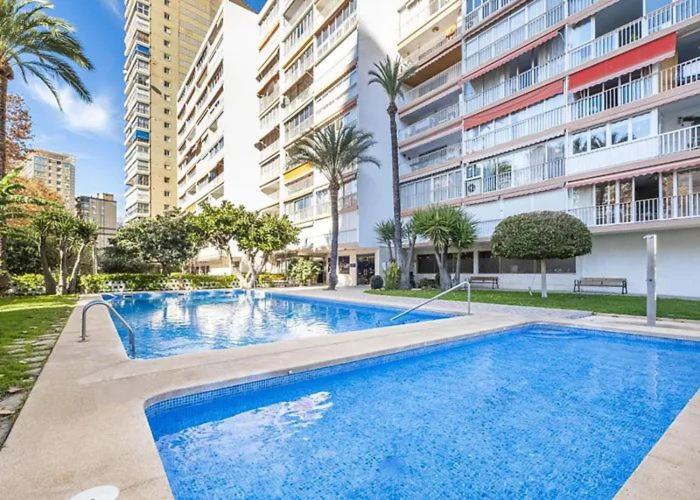 a large swimming pool in front of a building at Luxury Family Levante Beach in Benidorm