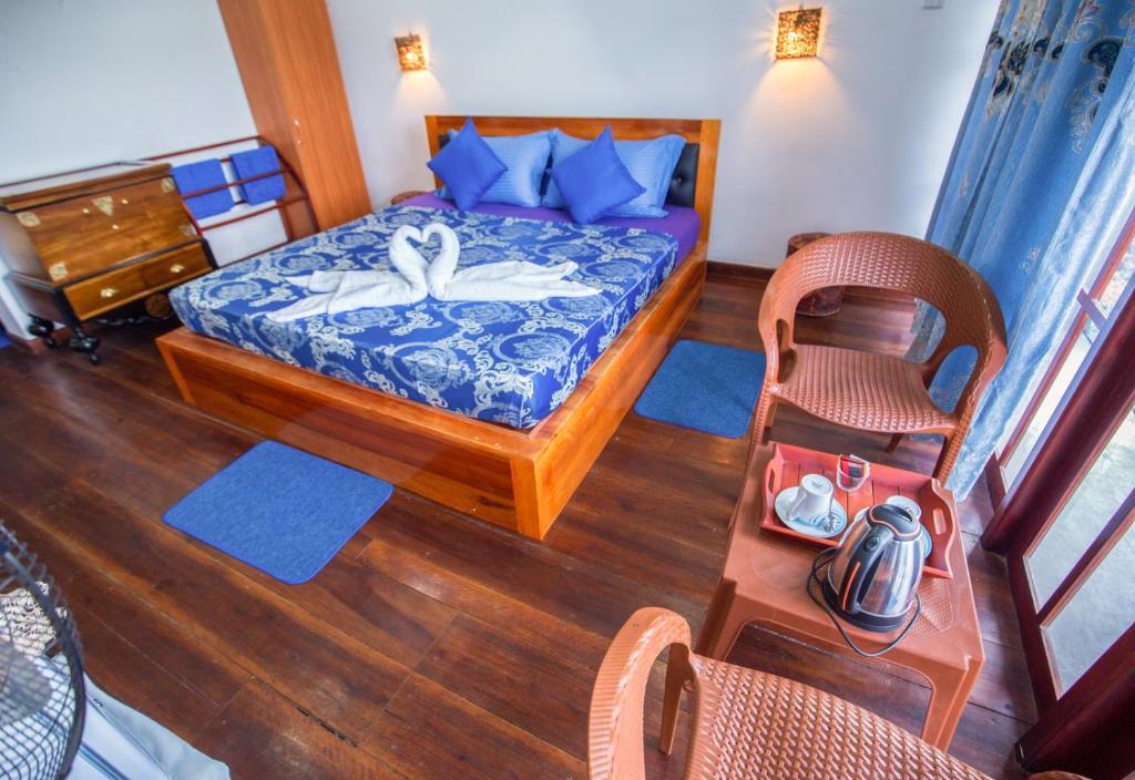 Postel nebo postele na pokoji v ubytování Ella Rawana Den Hotel