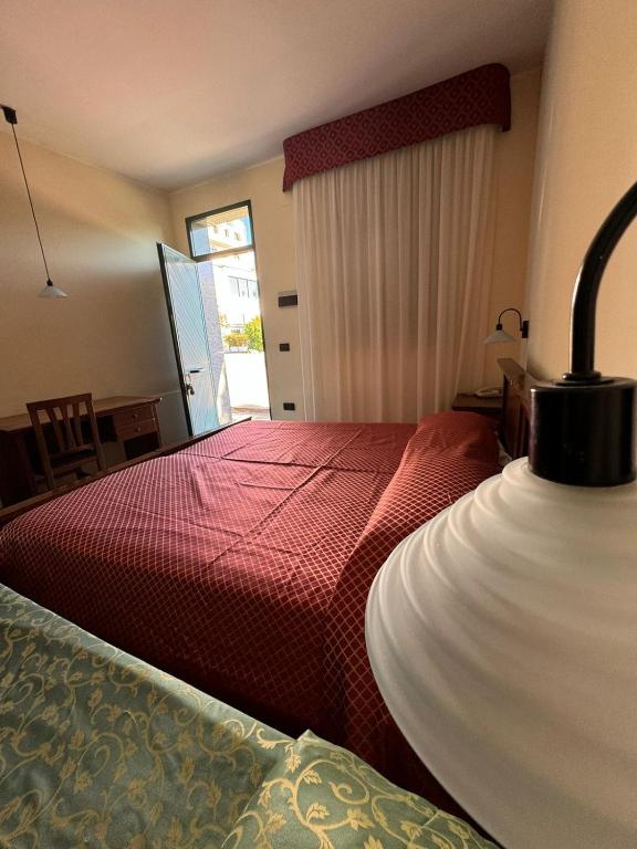 Postel nebo postele na pokoji v ubytování Hotel Arcobaleno
