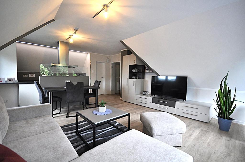 a living room with a couch and a table at Geschmackvolle moderne Apartment-Wohnungen in Hünfeld