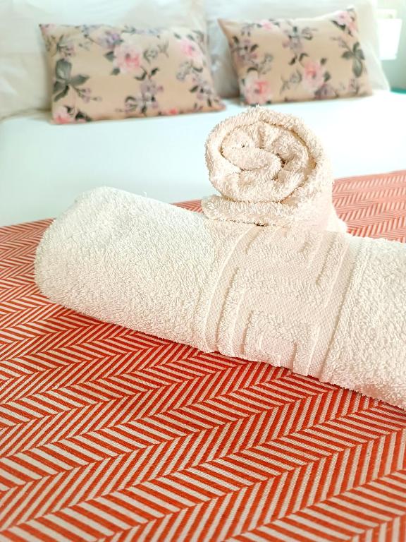 a towel is sitting on top of a bed at Hostal Cristina in Chipiona