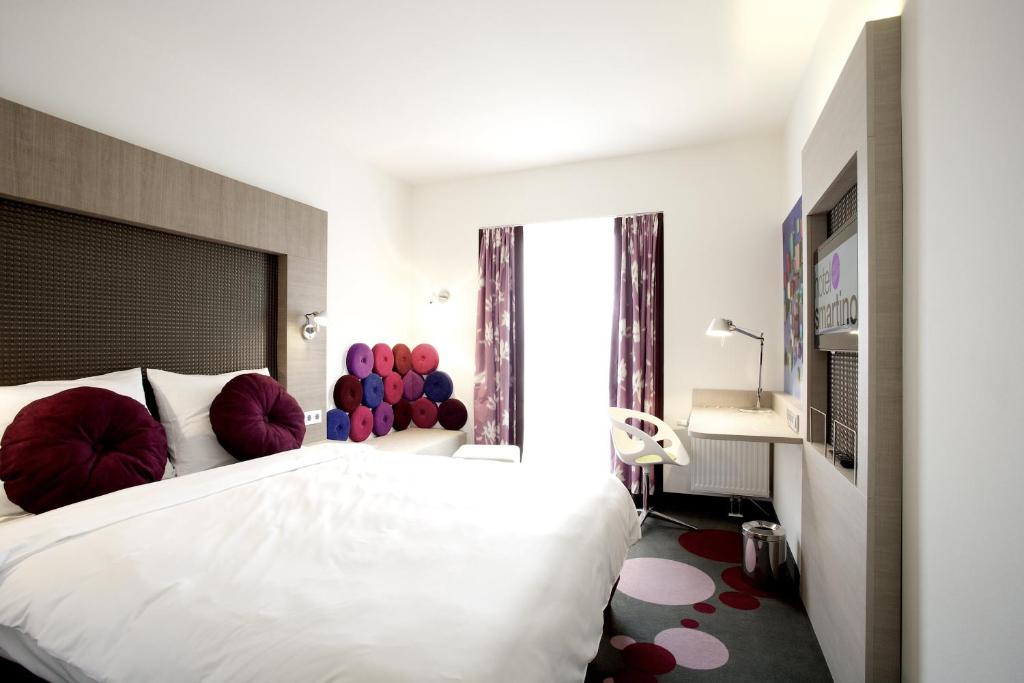 Postel nebo postele na pokoji v ubytování Hotel Smartino