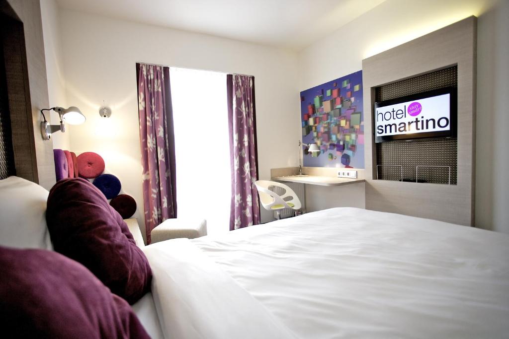 Postel nebo postele na pokoji v ubytování Hotel Smartino