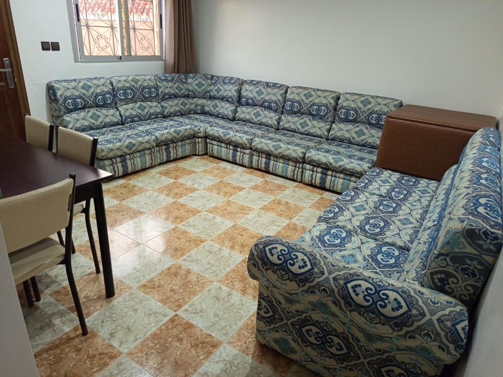 a living room with a couch and a table at Coopérative Village Jbel Moussa du Tourisme in Rcham