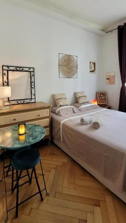 - une chambre avec 2 lits, une table et un miroir dans l'établissement Wonderful heart of Nice, à Nice