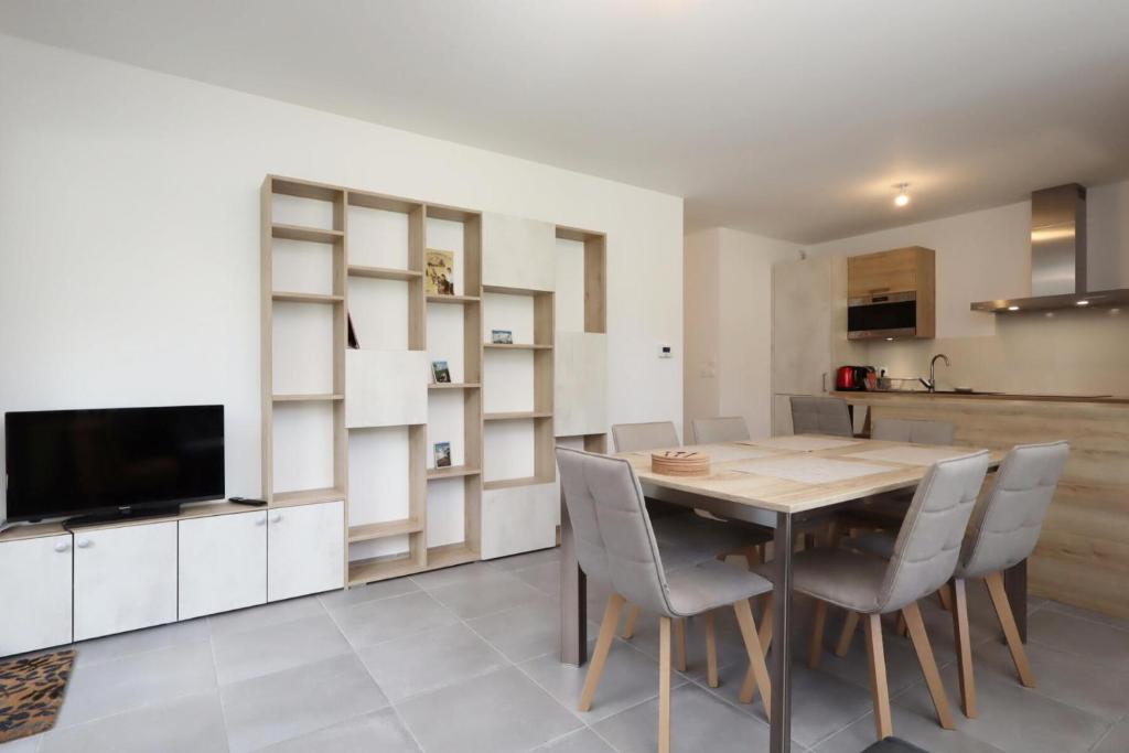a kitchen and dining room with a wooden table and chairs at Résidence Hameau Des Reines - Hameau des Reines MAE-9981 in Servoz