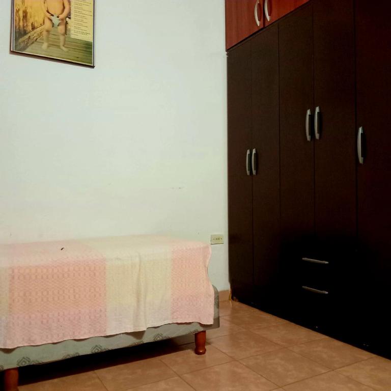 a bedroom with a bed and a dresser at Casa Marconi in Posadas