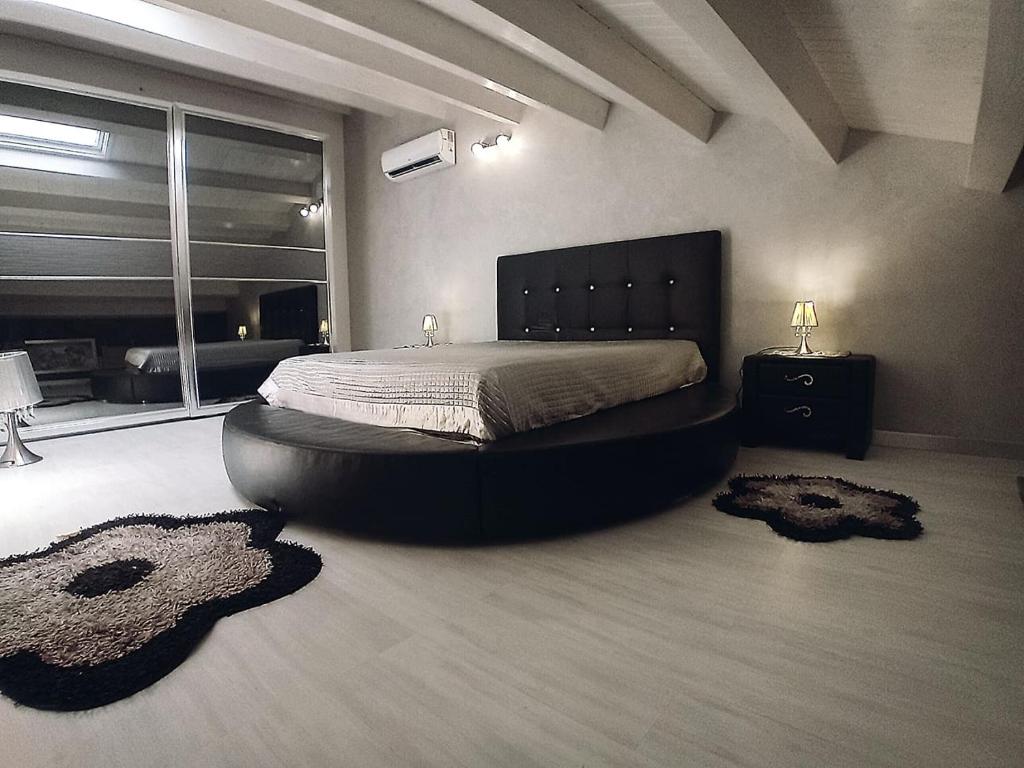 a bedroom with a large bed in a room with rugs at Casa vacanze Emma Siracusa Canicattini Bagni in Canicattini Bagni