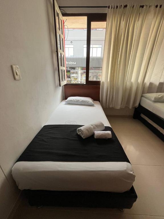 Postel nebo postele na pokoji v ubytování HOTEl OTUN PLAZA PEREIRA