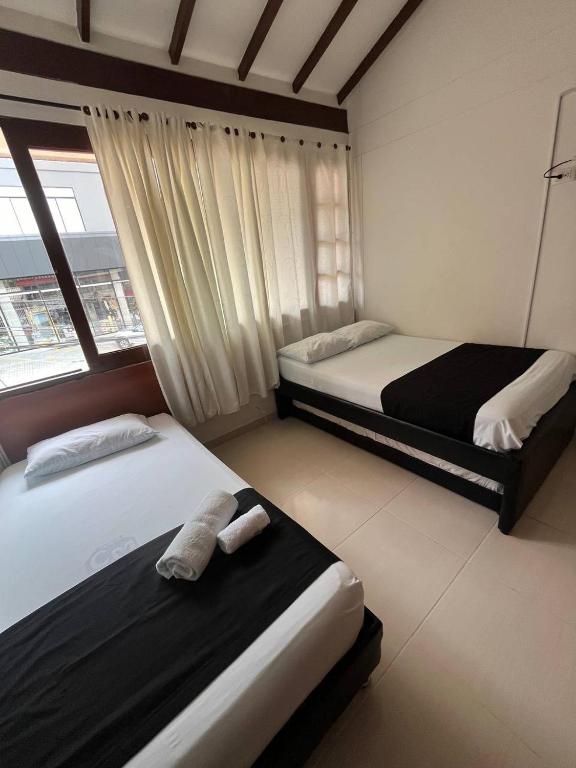 Postel nebo postele na pokoji v ubytování HOTEl OTUN PLAZA PEREIRA