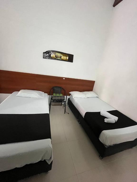 Postel nebo postele na pokoji v ubytování HOTEl OTUN PLAZA PEREIRA