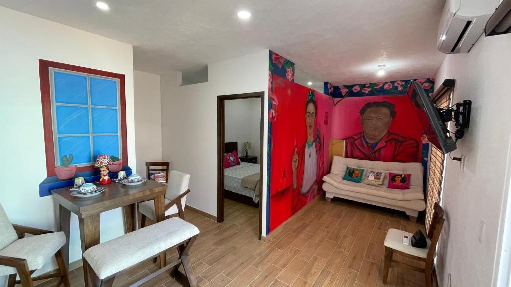 a room with a bedroom with a painting of a man at Frida Kahlo in Bucerías