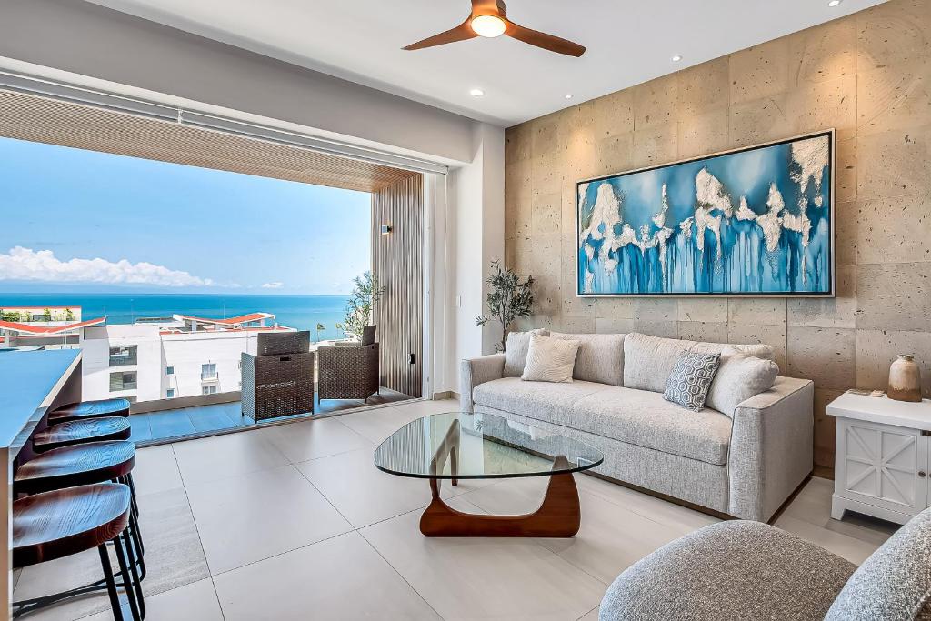 a living room with a couch and a table at Casa Cloud-9 at Maralma in Bucerías