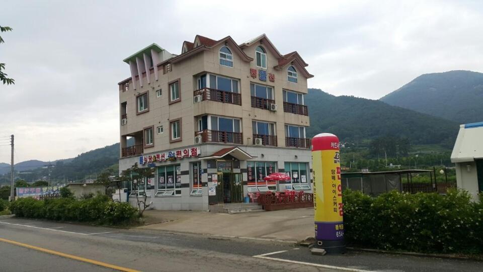 a large building on the side of a street at Yeosu Court Pension in Yeosu