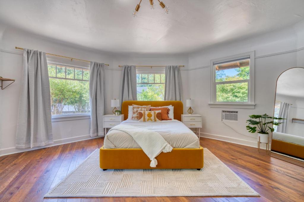 a bedroom with a bed in a room with windows at Stay Portland - Forest Studio Oasis - Mile from Multnomah Village in Portland