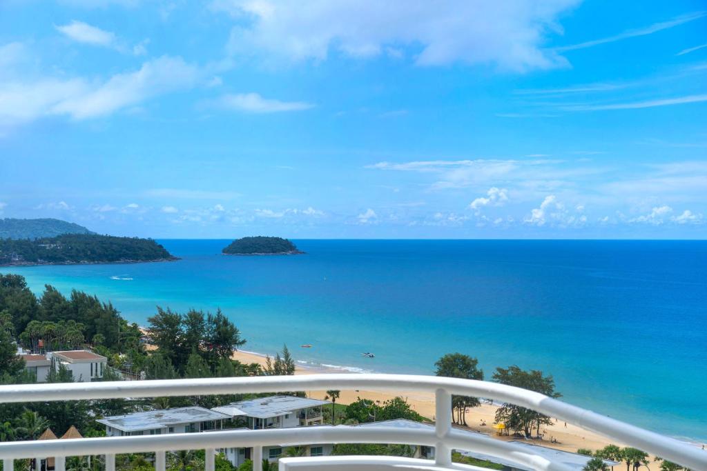 a view of the beach and ocean from a balcony at Chic Design & Full Seaview 2BR Karon Condo 16C, near Beach in Karon Beach