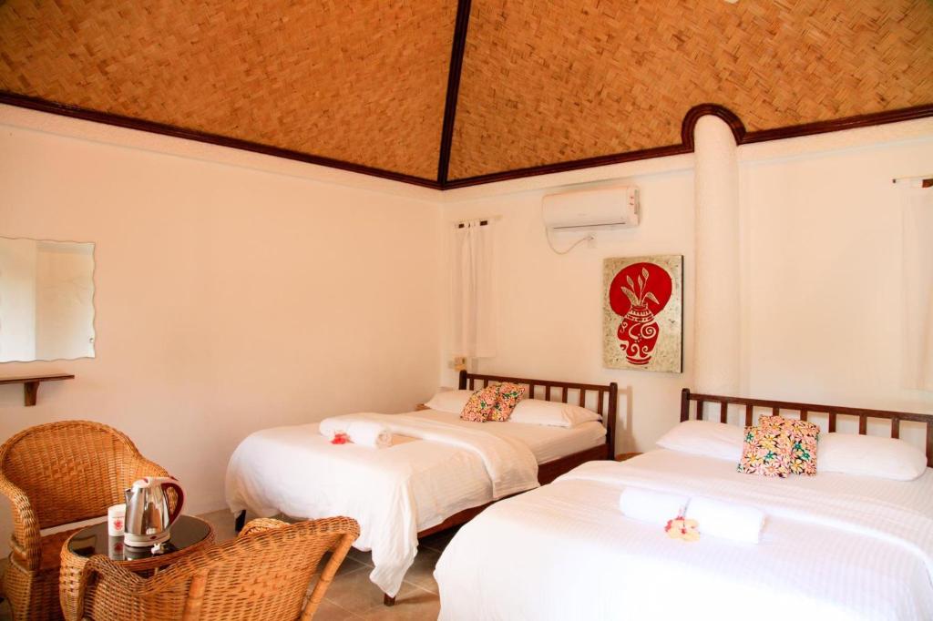 Postel nebo postele na pokoji v ubytování Sunz en Coron Resort