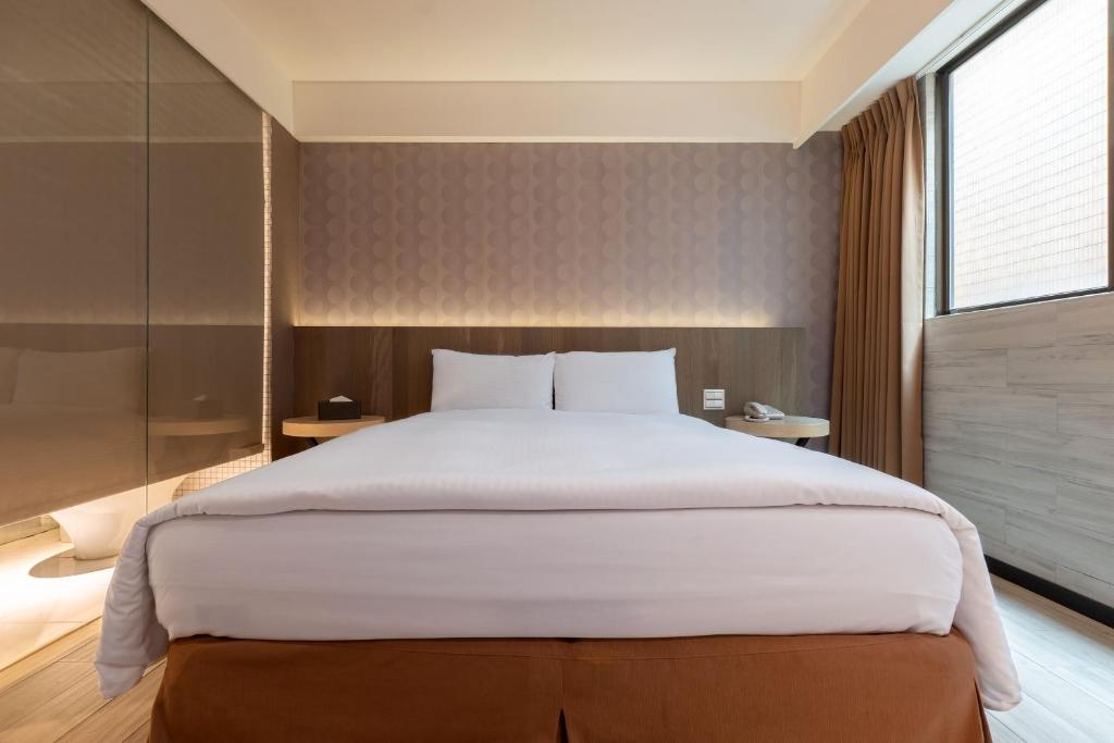Postel nebo postele na pokoji v ubytování Guide Hotel Taipei Fuxing North