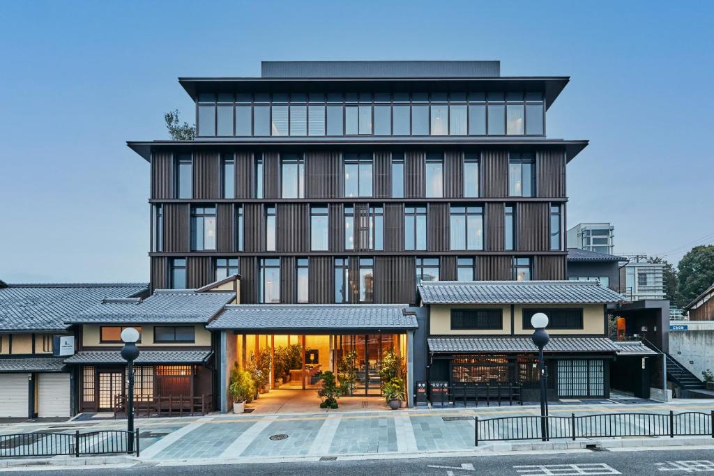 a large brown building with a lot of windows at NOHGA HOTEL KIYOMIZU KYOTO in Kyoto