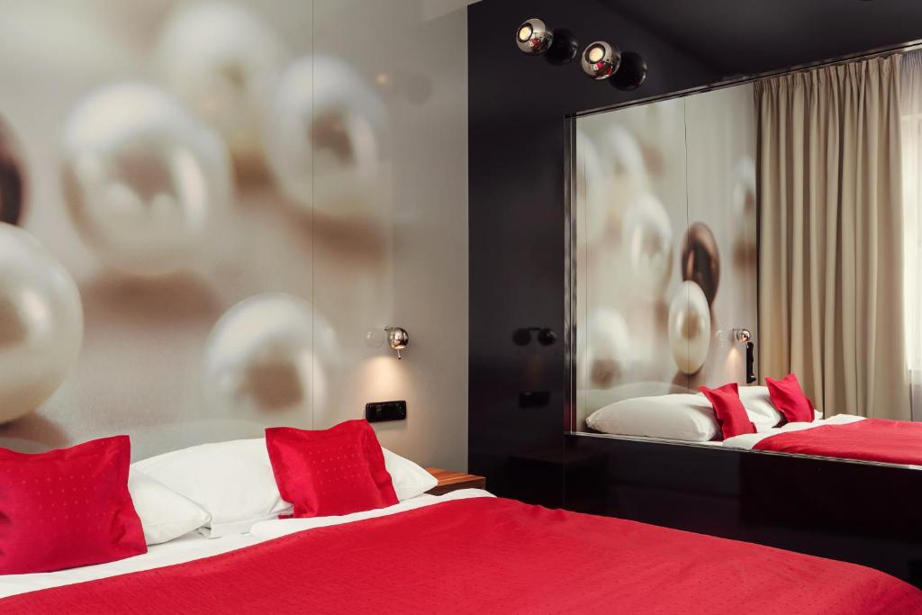 Postel nebo postele na pokoji v ubytování Perla Hotel