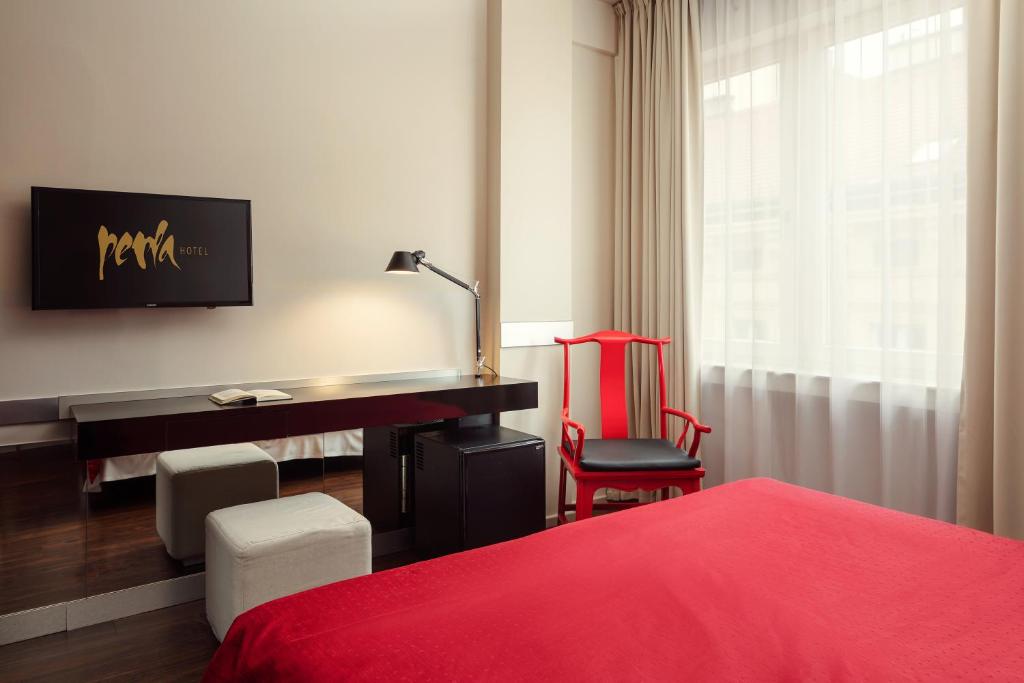 Postel nebo postele na pokoji v ubytování Perla Hotel