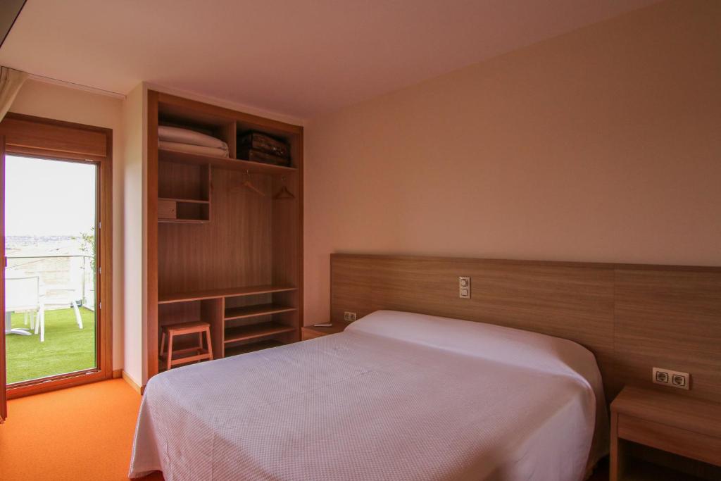 Posteľ alebo postele v izbe v ubytovaní Hotel Cal Piteu