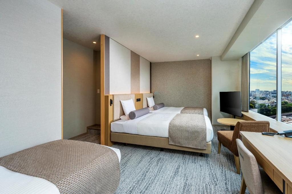 Postel nebo postele na pokoji v ubytování ART HOTEL Nippori Lungwood