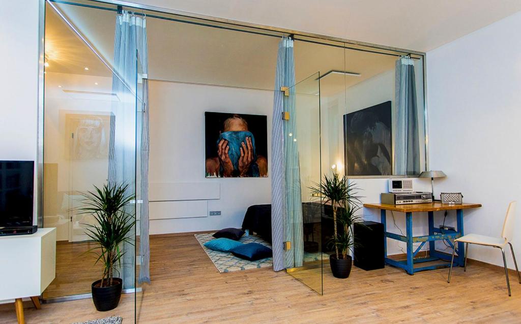 d'un salon avec une table et un mur en verre. dans l'établissement Laksa Apartments, à Budapest